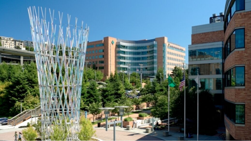two tall brick buildings and a metal sculpture at the fred hutchinson cancer research center