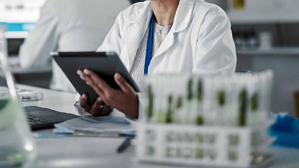 researcher accesses lims system on tablet at workbench